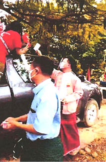 NLD’s Amyother Hluttaw candidate Saw Shar Paung Aur giving cash to party supporters during campaign rally in Kyar-in-seit-kyee Township