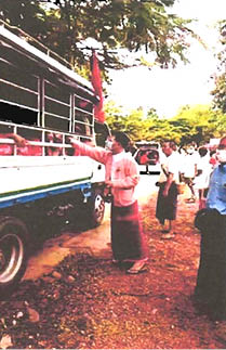 NLD’s Amyother Hluttaw candidate Saw Shar Paung Aur giving cash to party supporters during campaign rally in Kyar-in-seit-kyee Township